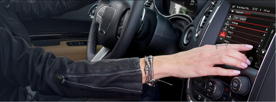 Jeep Uconnect Infotainment System A woman using the Jeep Connect Infotainment System