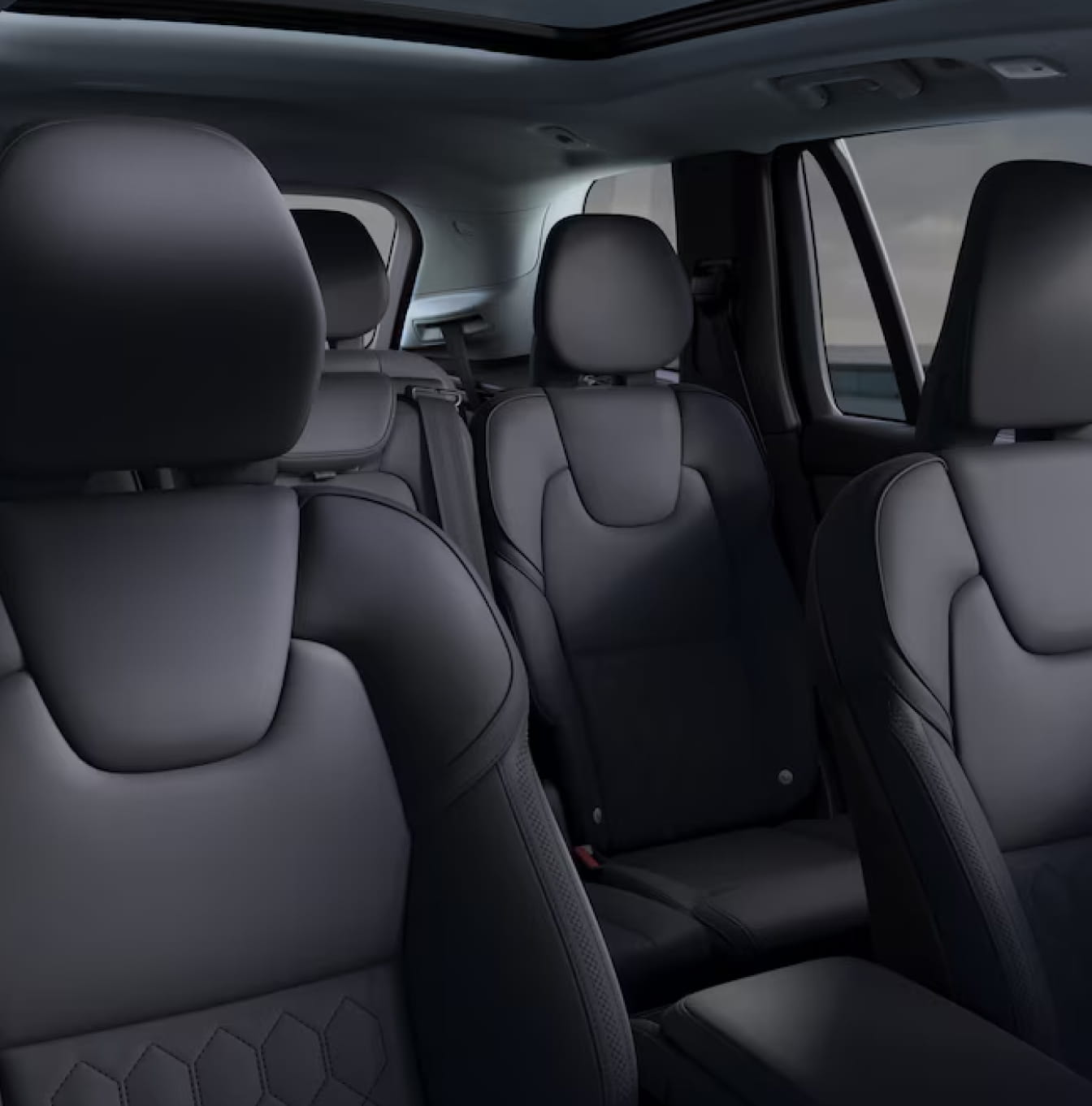 Volvo XC90 Plug-In Hybrid cabin featuring black three-row seating and a panoramic roof.