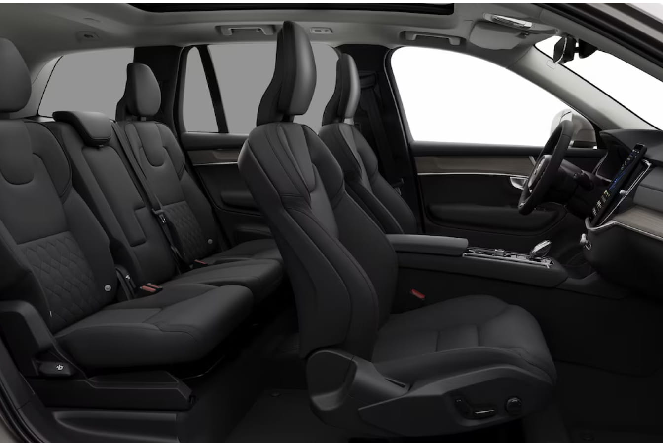 Volvo XC90 Plug-In Hybrid interior featuring black seating across three rows, a panoramic roof, and a driver-focused cockpit.