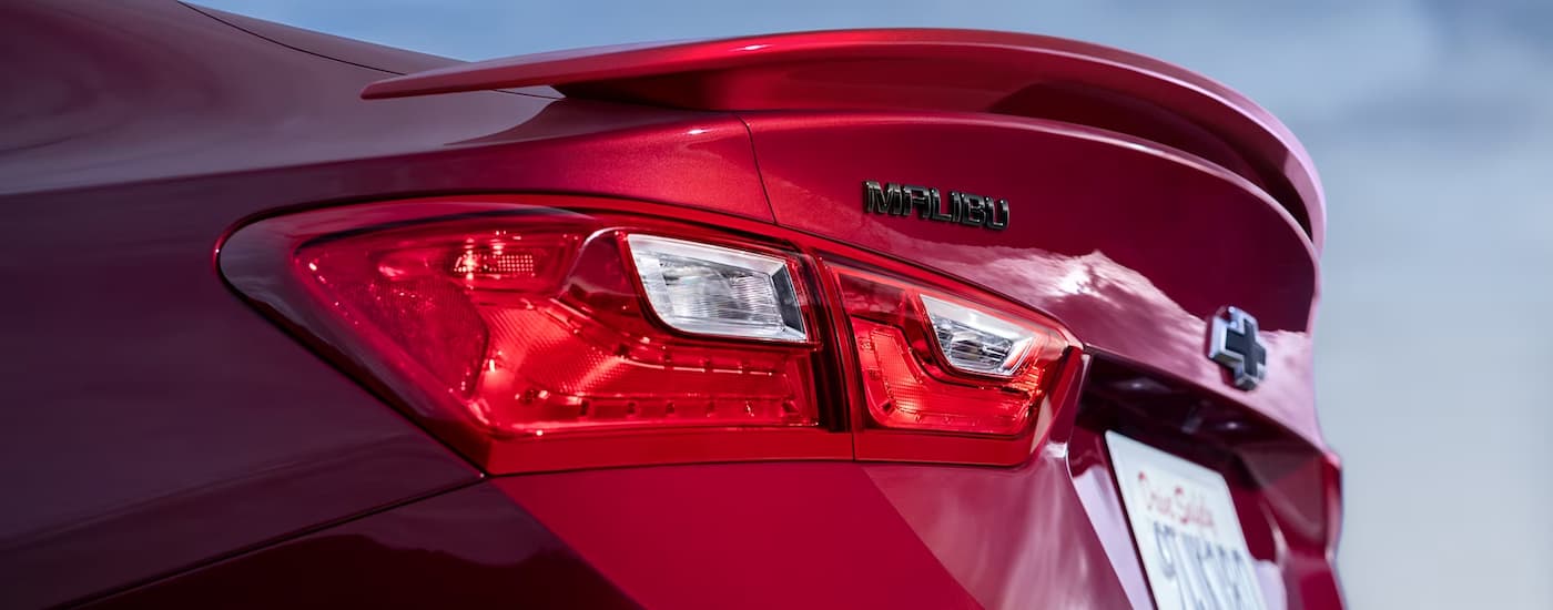 A close up of the rear of a red 2024 Chevy Malibu shows the taillight.