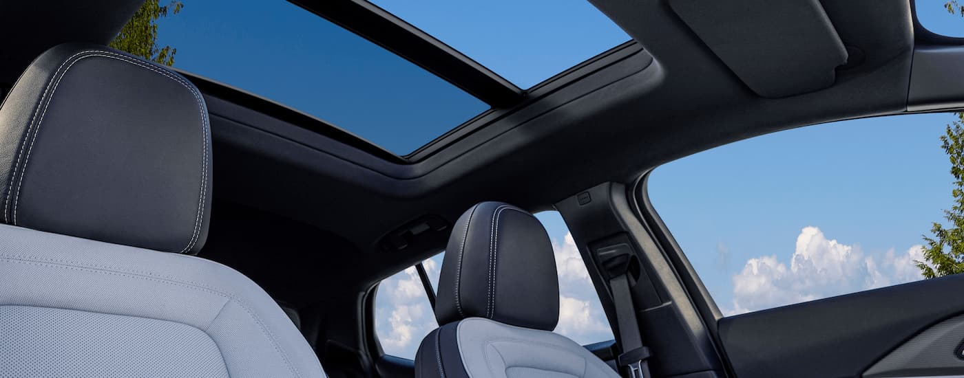The black and grey interior of a 2024 Chevy Equinox EV 3LT shows the headrests and sunroof.