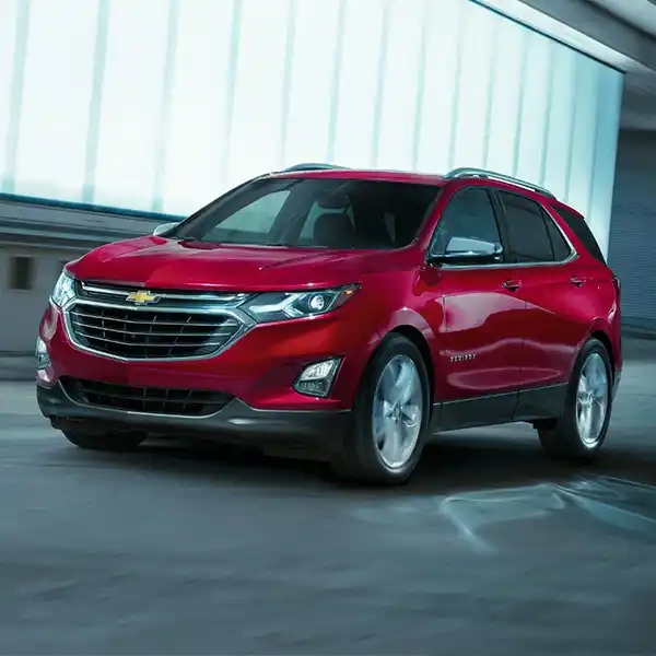 Red Chevrolet Equinox SUV parked in a lot at Dave Gill Chevrolet in Columbus, OH