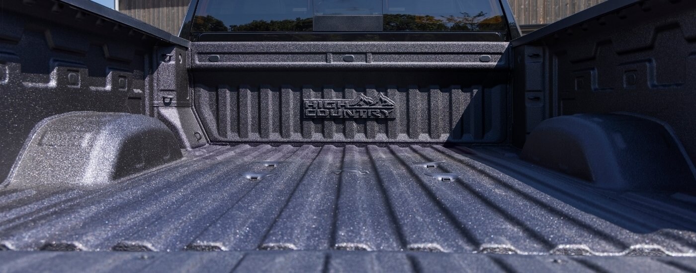 2025%20Chevy%20Silverado%202500%20HD%20High%20Country%20-%20Bed.jpg A close-up shows the bed of a black 2025 Chevy Silverado 2500 HD High Country.