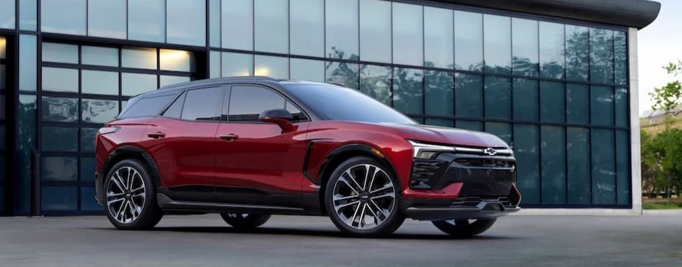 2024%20Chevy%20Blazer%20EV%20-%20Red.jpg A red 2024 Chevy Blazer EV is shown parked near a glass building.