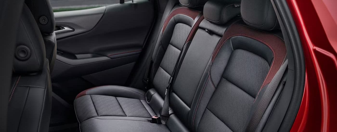 The rear black leather seats are shown in a 2025 Chevy Equinox RS.