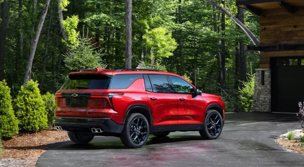 2024 Chevy Traverse - Rear.jpg A red 2024 Chevy Traverse is shown parked on a driveway.