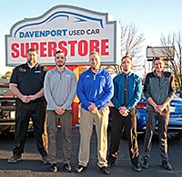 McGrath staff standing on car lot