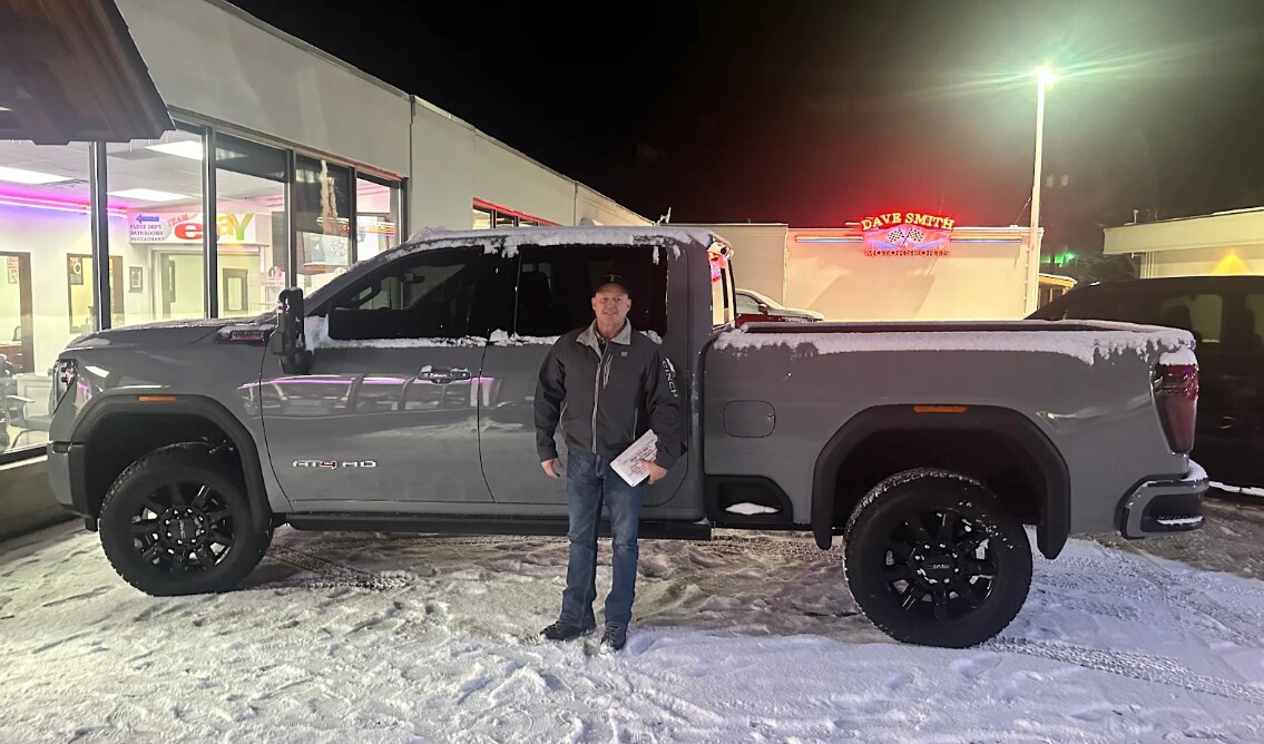 Happy man with custom RAM truck bought from Dave Smith Motors