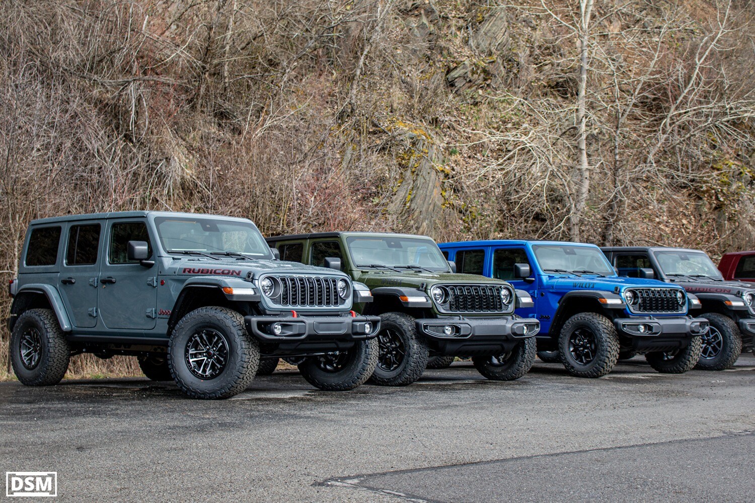 Lineup of 4 jeep wranglers in grey, green, blue, and white in front of Daev Smith Motors