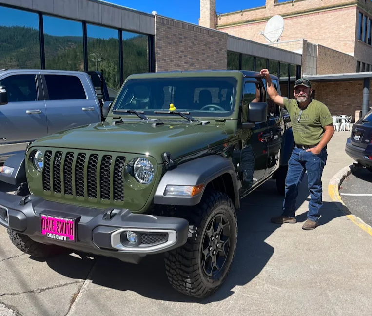 Man standing in front of newly bought Jeep Wrangler outside of Dave Smith Motors