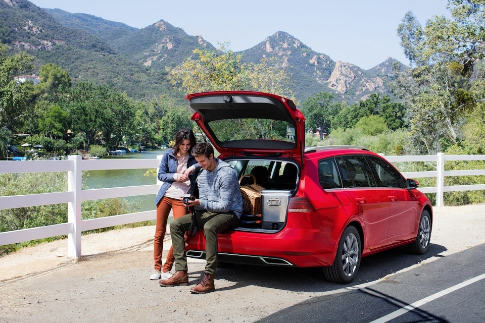 man and woman sitting in trunk man and woman sitting in trunk