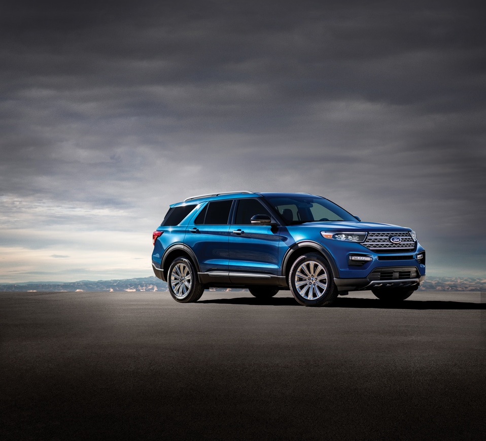 2020-Ford-Explorer-ST-SUV-L02 (2).png blue Ford Explorer SUV parked on a black tarmac with a grey sky overhead