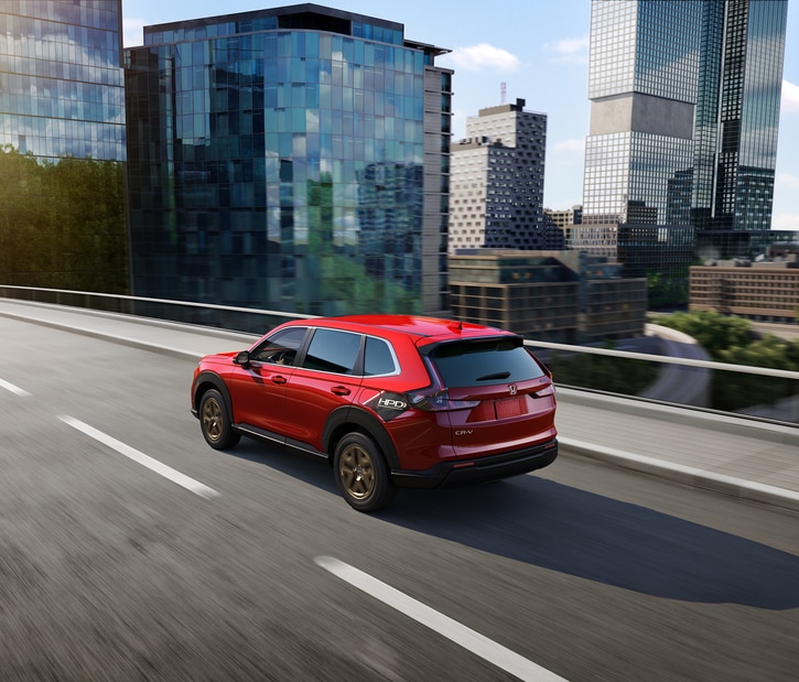 2023-Honda-CRV-EX-SUV.png new red Honda CR-V SUV driving through into the city from a freeway offramp