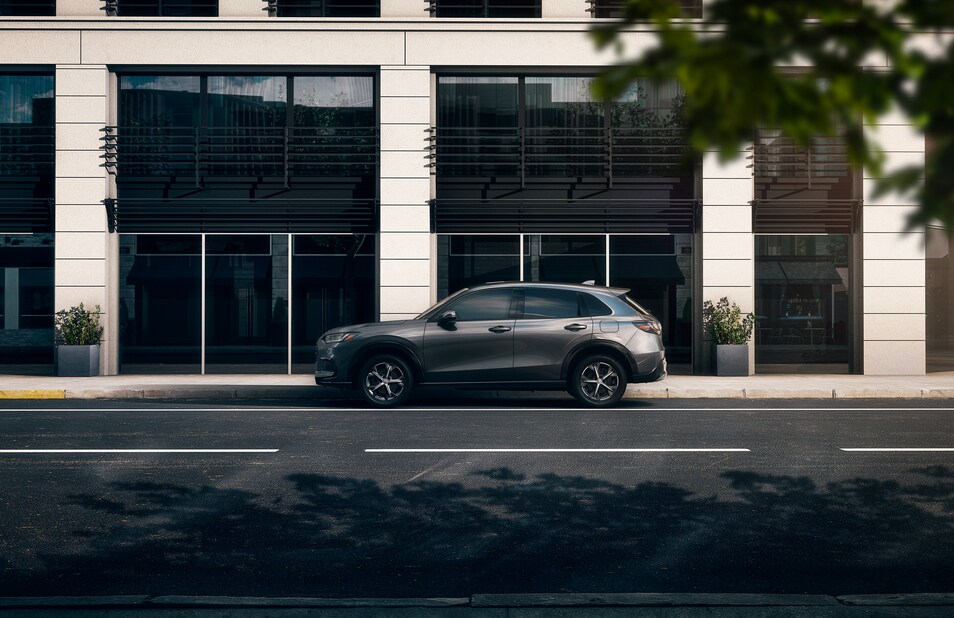 2023-Honda-HRV-EXL-SUV.png dark gray Honda HR-V crossover SUV parked in front of a large municipal building
