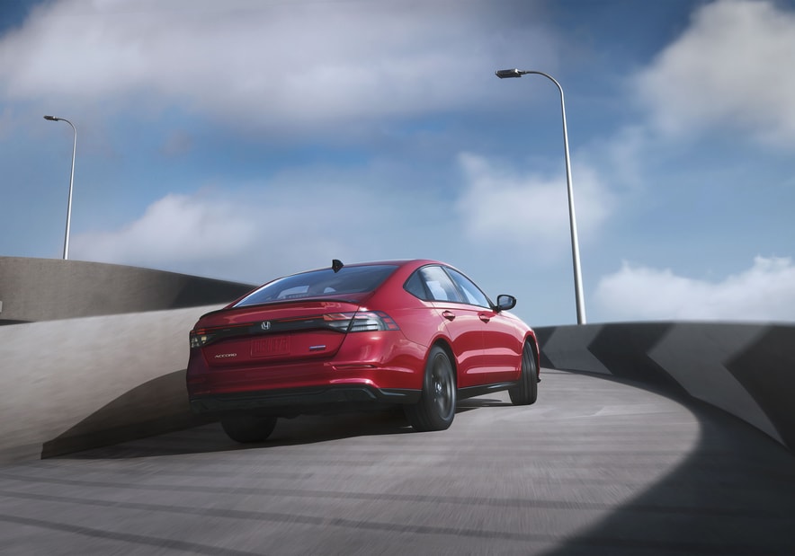 2024-Honda-AccordHybrid-Sport-L-Sedan.png red Honda Accord sedan driving up a curved, cement structure