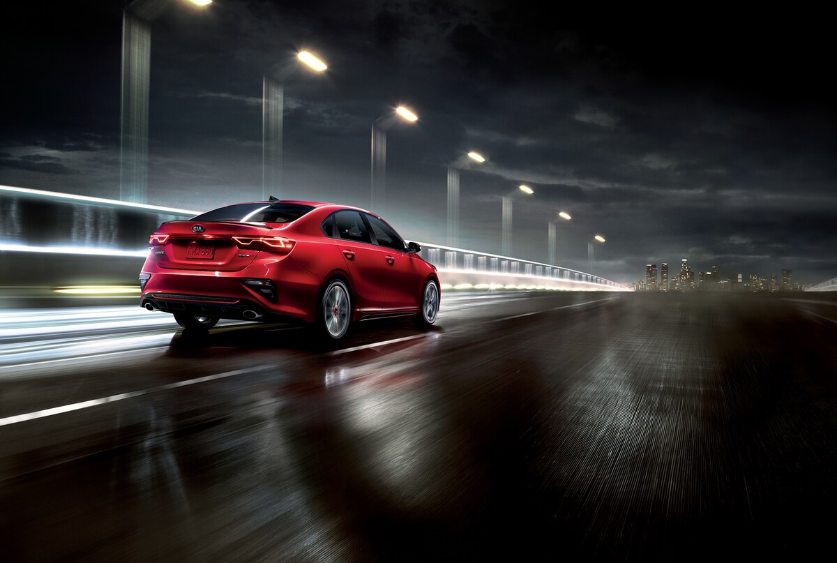 2021-KIA-Forte-GT-GT2Package-Sedan-L03.png red Kia Forte car driving on a bridge at night