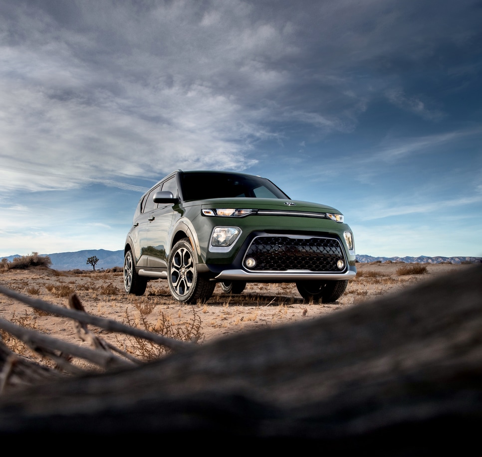 2022-KIA-Soul-XLine-SUV.png green Kia Soul compact SUV parked in a sandy desert