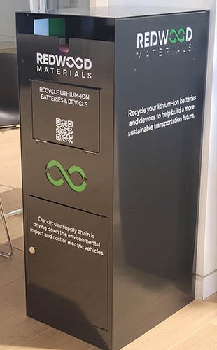 Redwood Materials Bin at Audi Millburn. Tall black Redwood materials recycling bin in the service area of Audi Millburn.