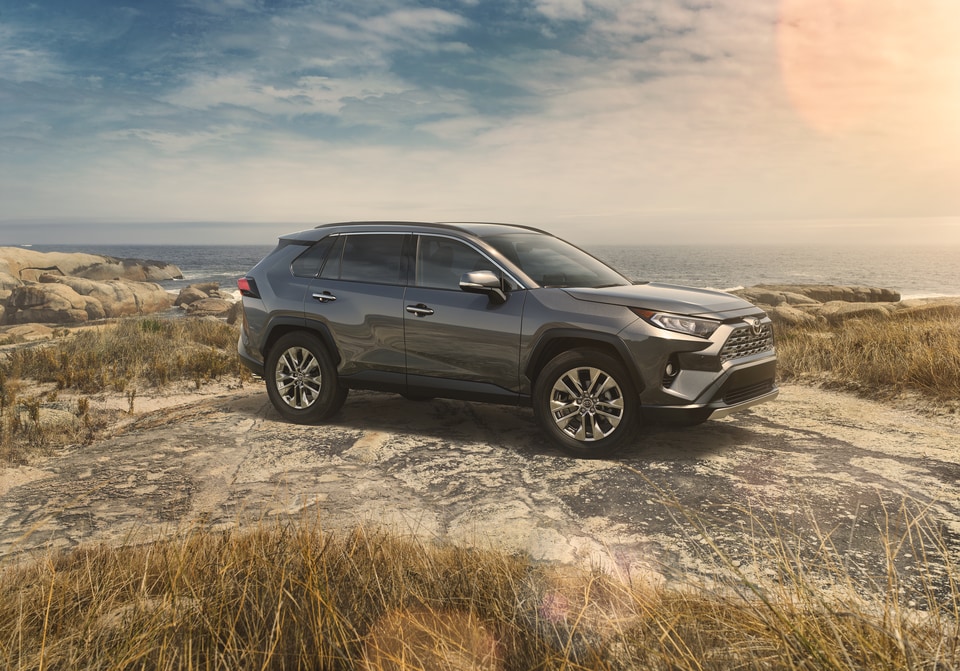 2019-Toyota-RAV4-Limited-SUV-L04.png dark gray Toyota RAV4 SUV parked at the beach