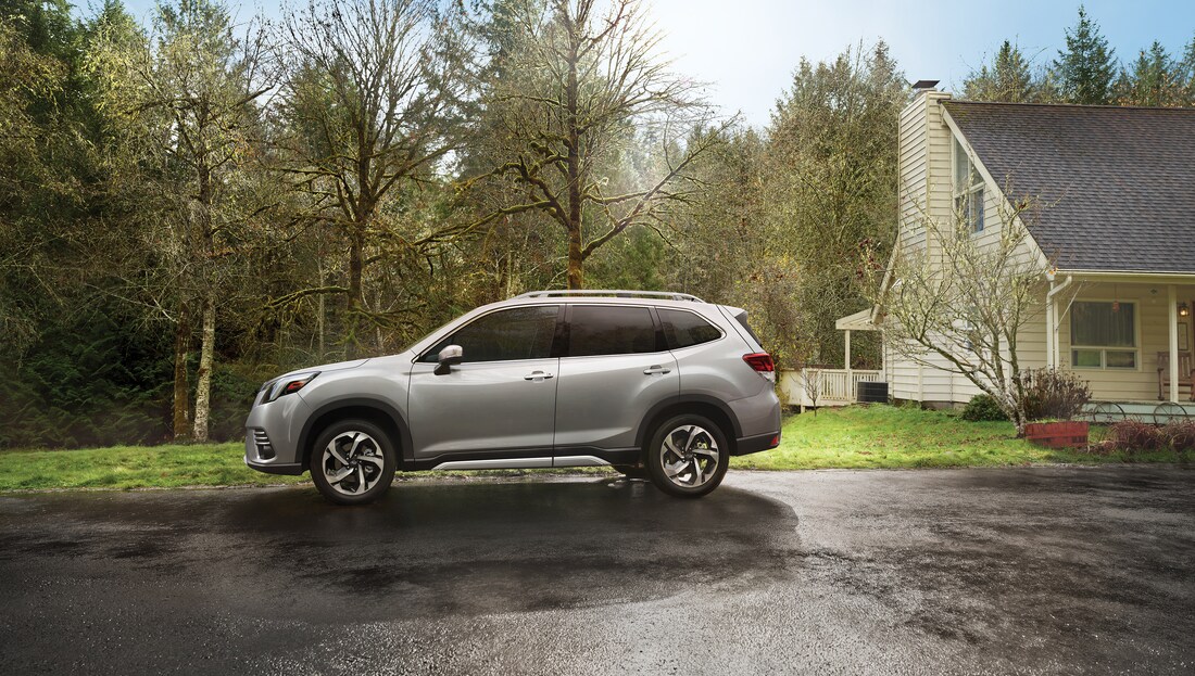 2023-Subaru-Forester-Touring-SUV-L04.png white Subaru Forester SUV parked in front of a single family home