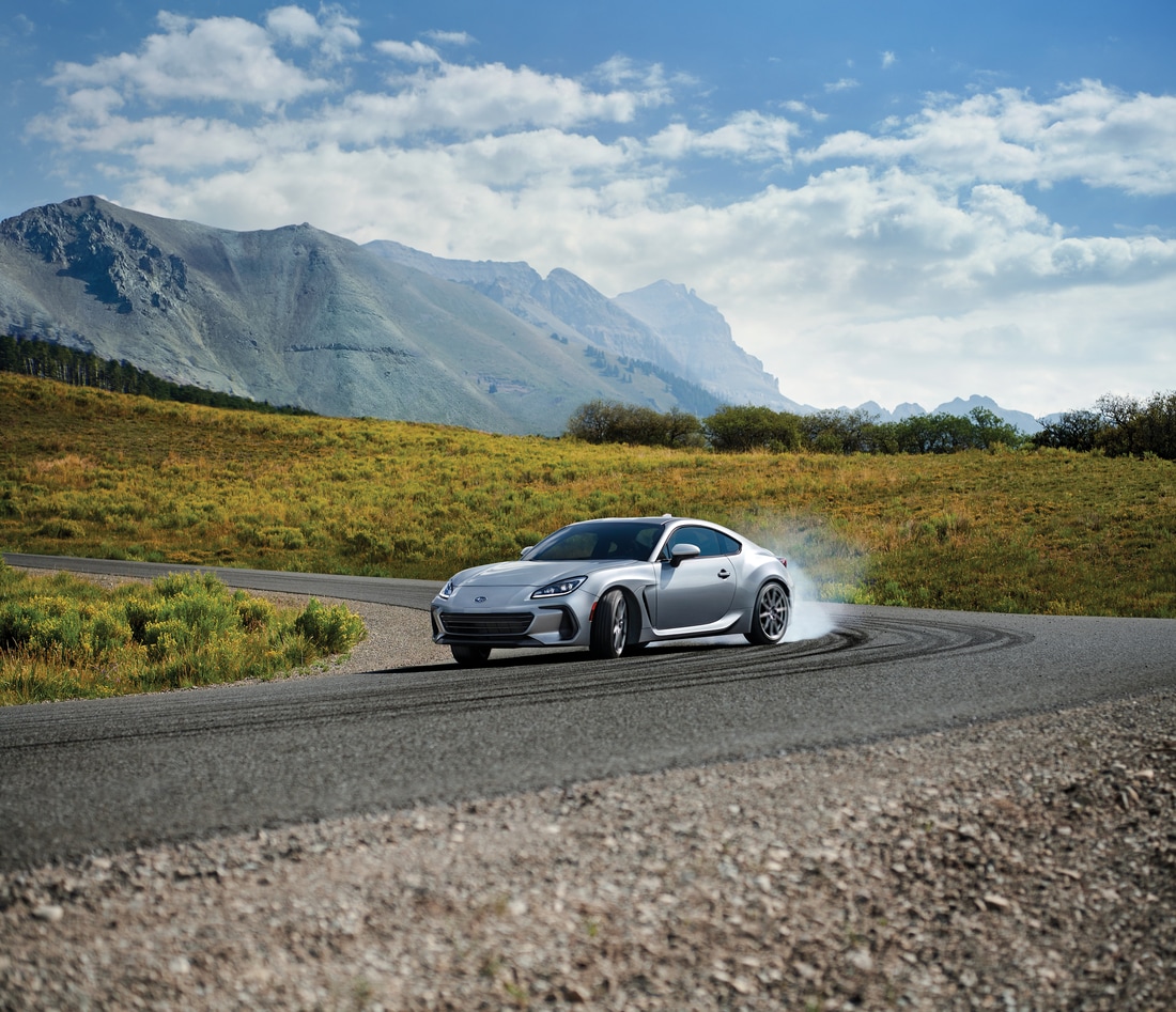 2023-Subaru-BRZ-Limited-Coupe-L03.png silver Subaru BRZ sport coupe driving fast along a highway