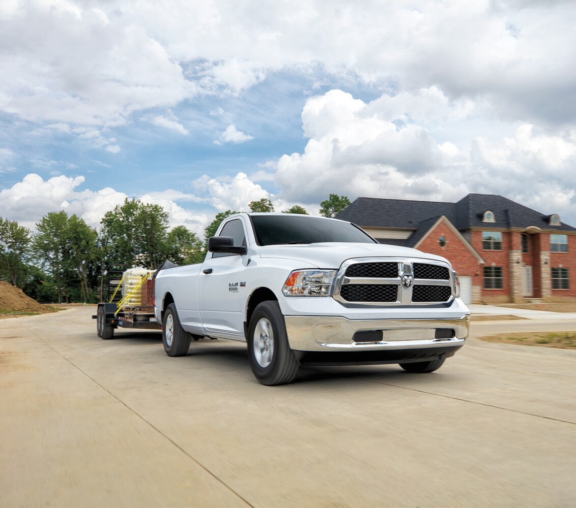 2023-RAM-1500-Classic-Tradesman-RegularCab-Truck.png white Ram 1500 truck parked at a construction site