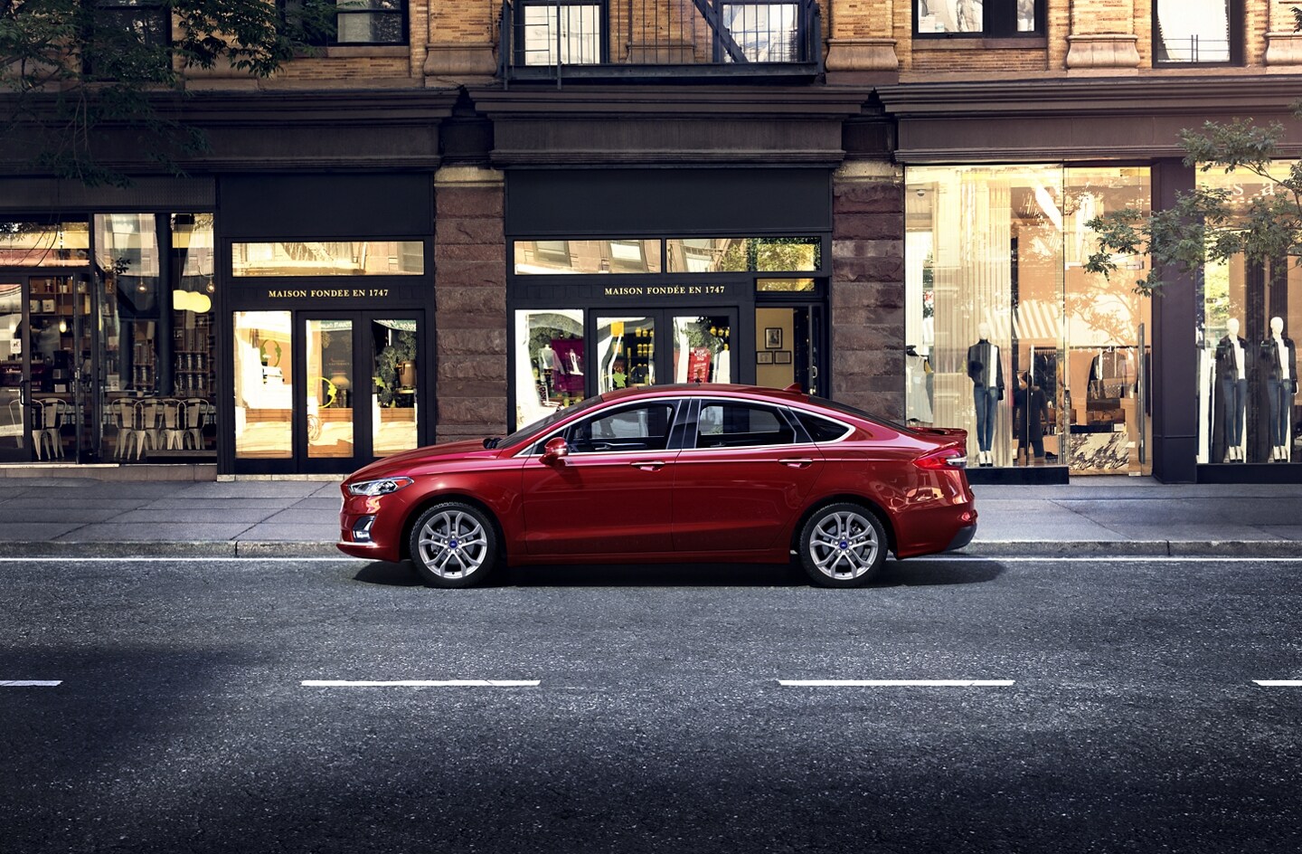 Red 2020 Ford Fusion parked on a busy street