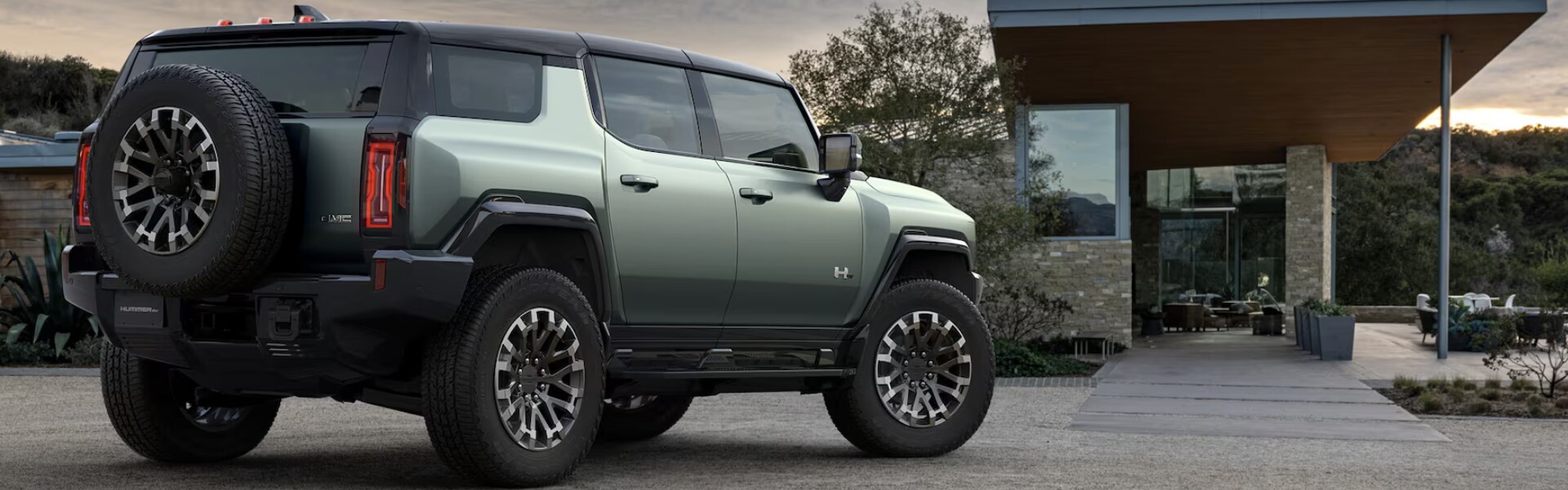 2024 GMC HUMMER EV parking outdoor view from the side.png 2024 GMC HUMMER EV parking outdoor view from the side