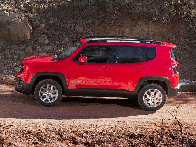2017 Jeep Renegade SUV red facing left on dirt road by rocky ledge.jpg