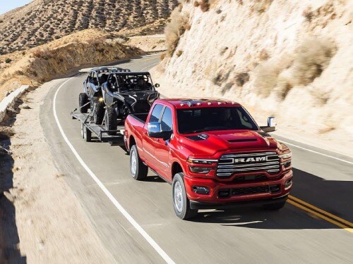 2025 RAM 2500 towing two side-by-sides