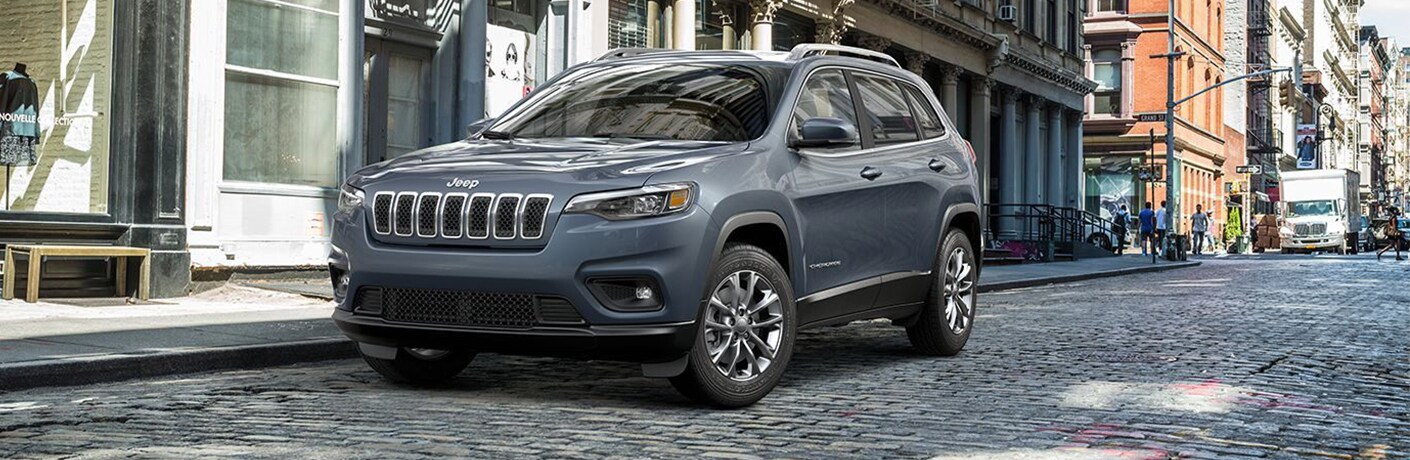2019 Jeep Cherokee exterior shot with gray metallic paint color parked on a stone-tiled roadway