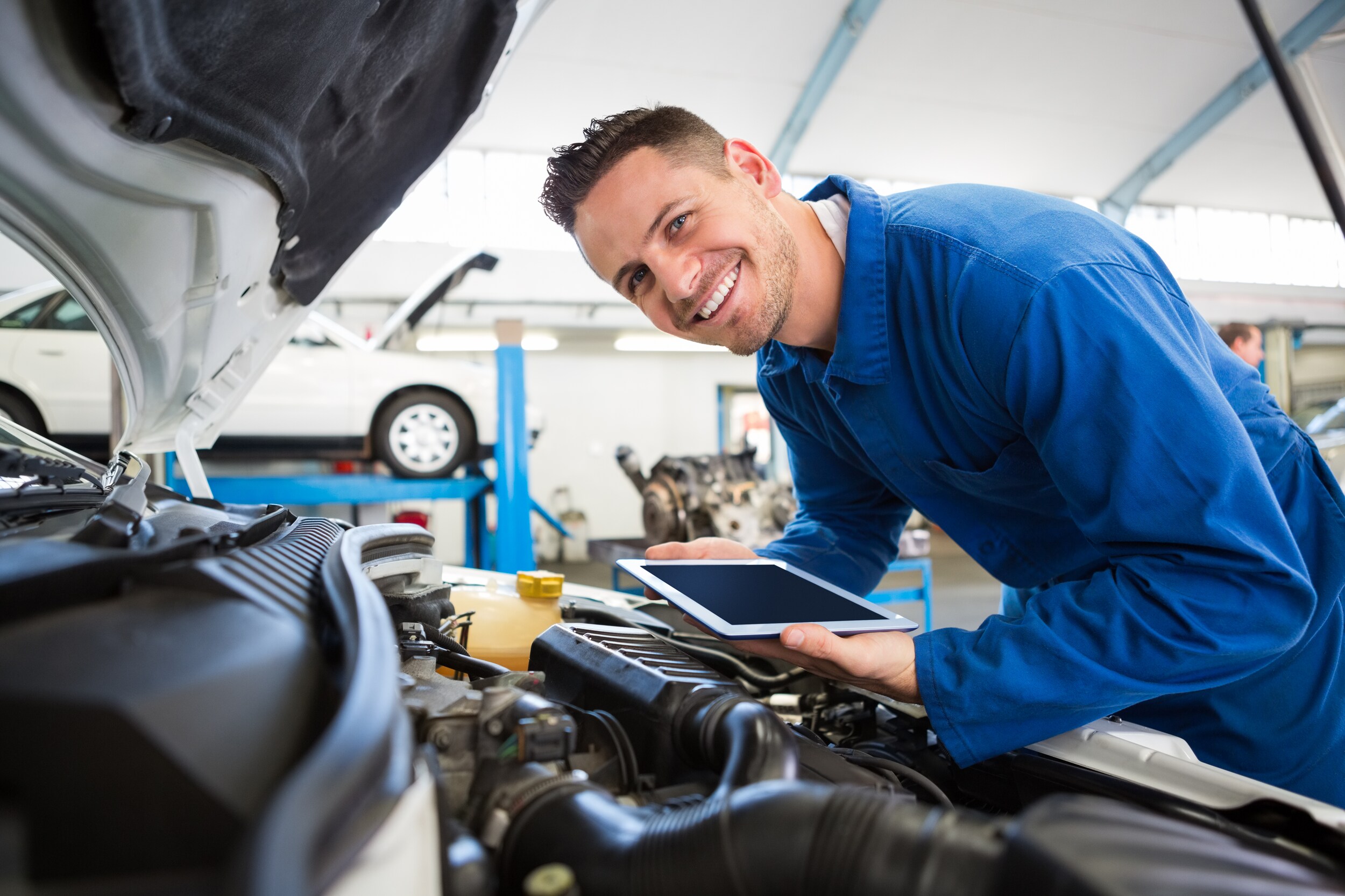 smiling male mechanic blue.jpg