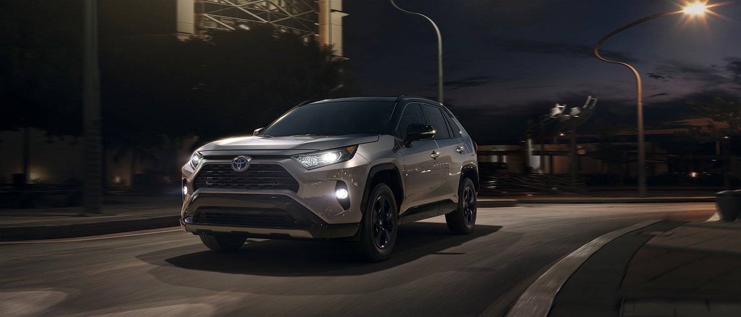 RAV_MY19_0017_V001.jpg RAV4 Hybrid driving down the city street at night