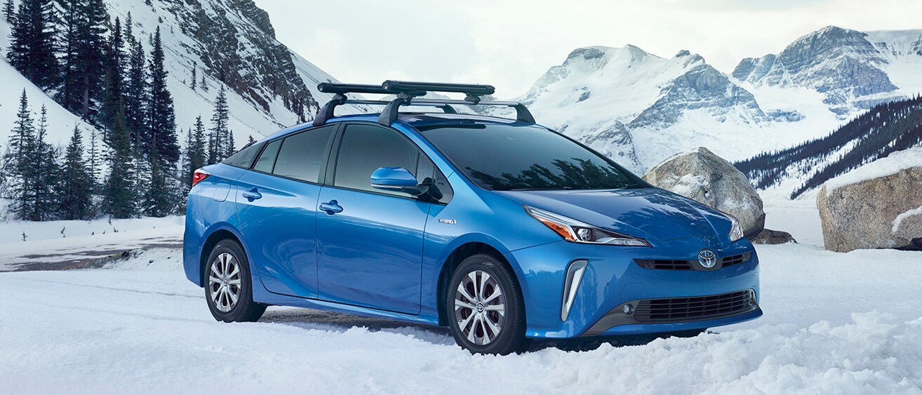 PRS_MY19_0059_V001.jpg Blue 2019 Prius Hybrid in the snowy mountains
