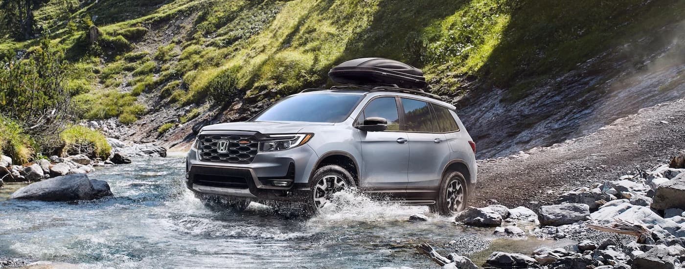 A silver 2022 Honda Passport Trailsport is shown from the front at an angle.