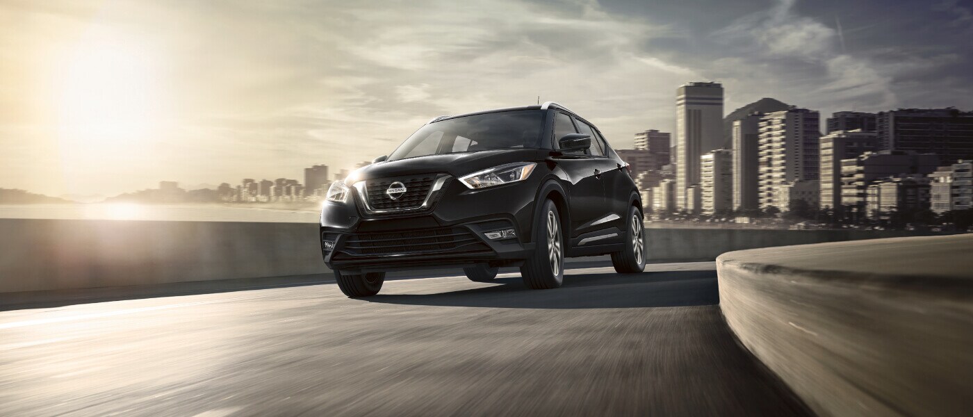 2020 Nissan Kicks A black 2020 Nissan Kicks driving away through a city on the highway