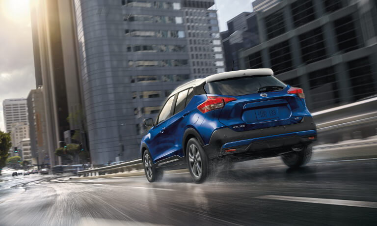 2020 Nissan Kicks A blue 2020 Nissan Kicks driving through a city street
