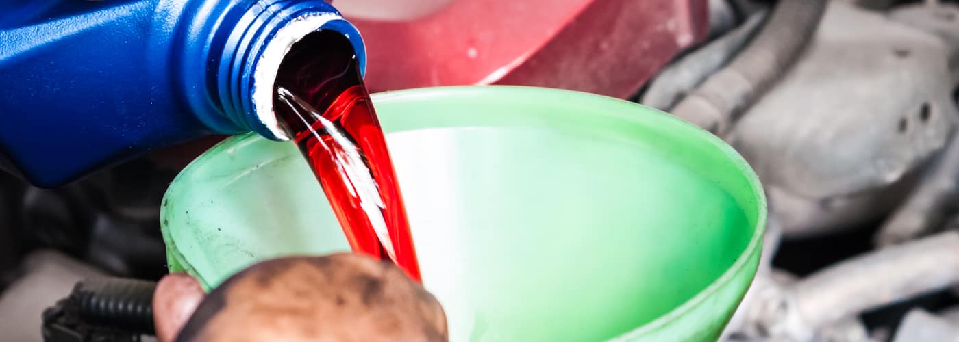 mechanic-pouring-in-transmission-fluid_34694905.jpg