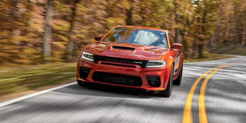 2023 Dodge charger driving through forested area