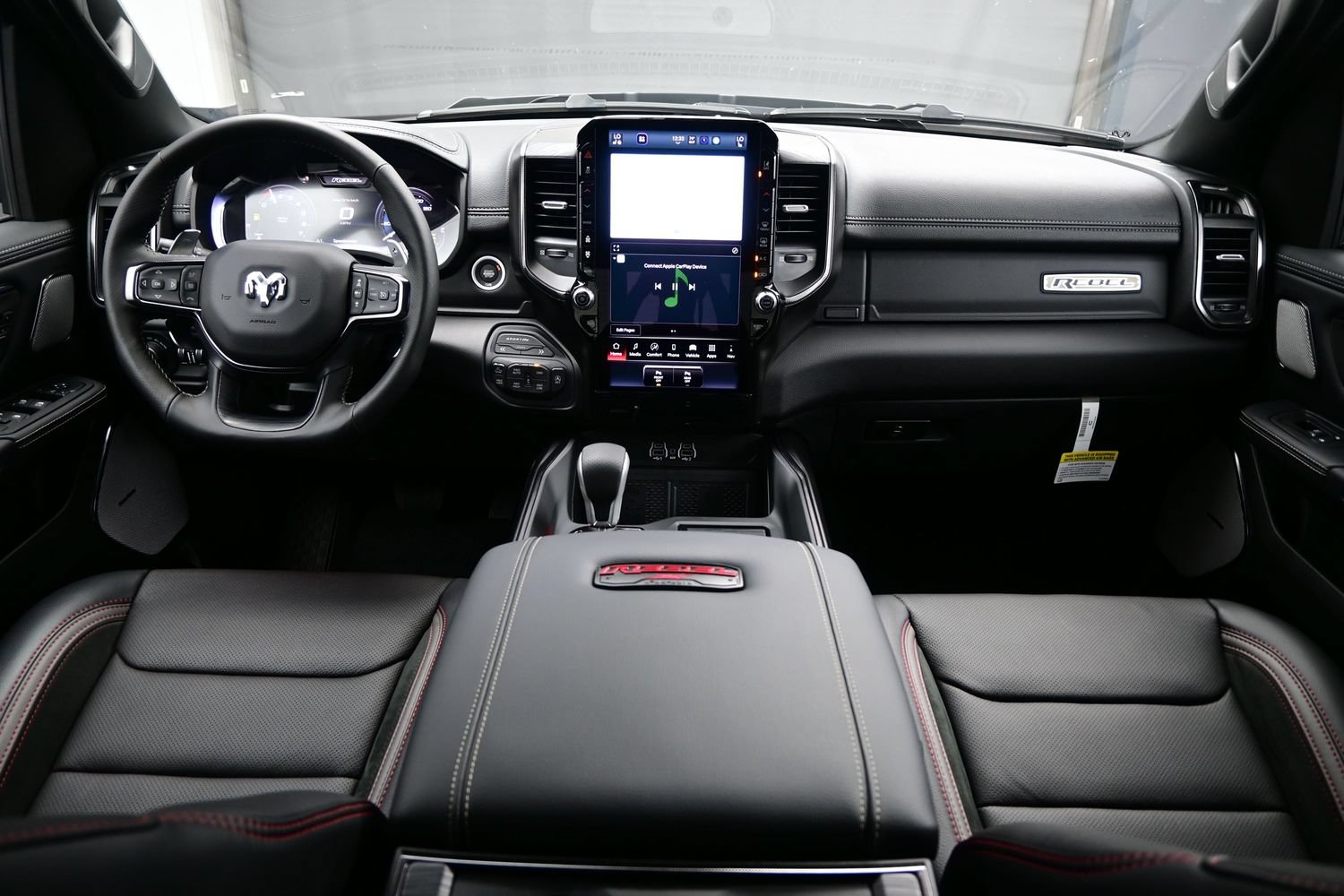 Ram 1500 Rebel dashboard with vertical Uconnect touchscreen and red accents