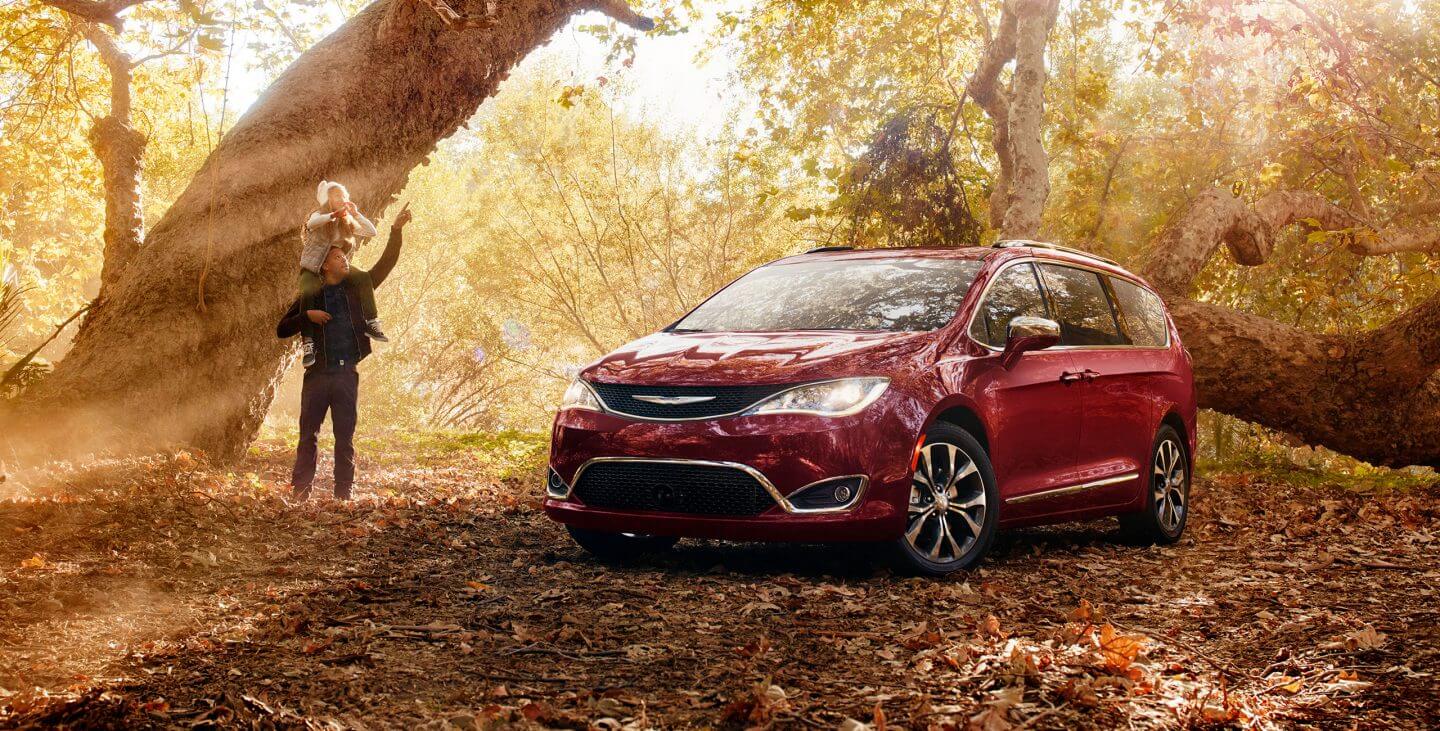 2018 Chrysler Pacifica parked in forest by a tree