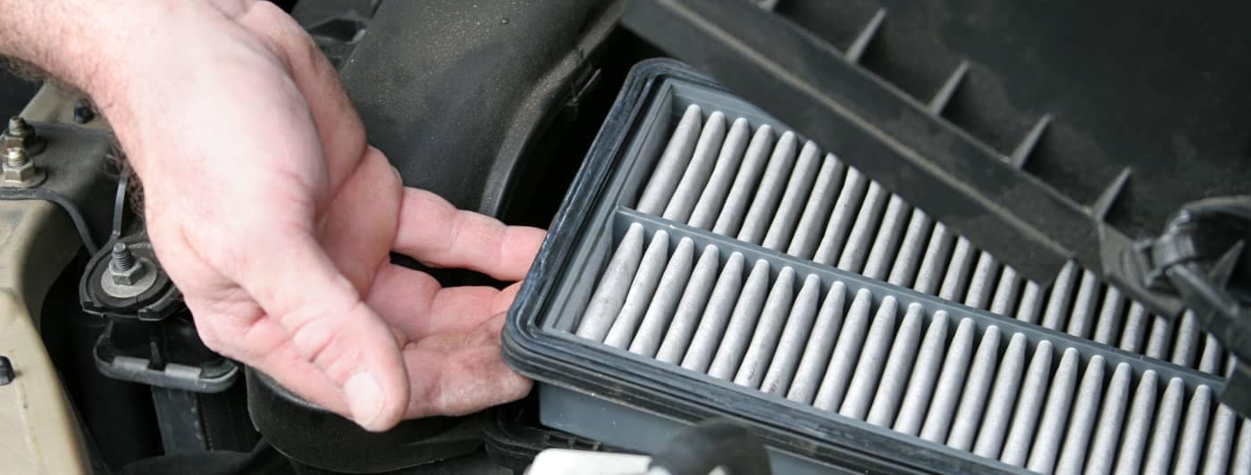 man checking air filter