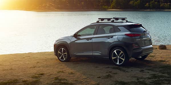 2019 Hyundai Kona SUV parked at a lake at sunset