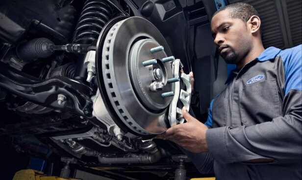 Ford Service technician working on brakes