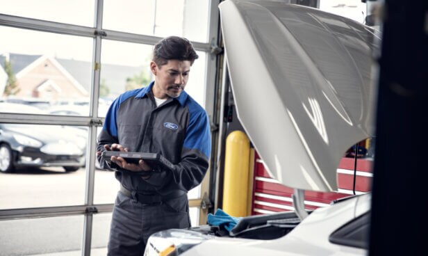Ford Service technician inspecting vehicle