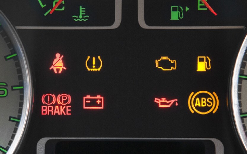 A digital dashboard showing the battery alert symbol illuminated in red.