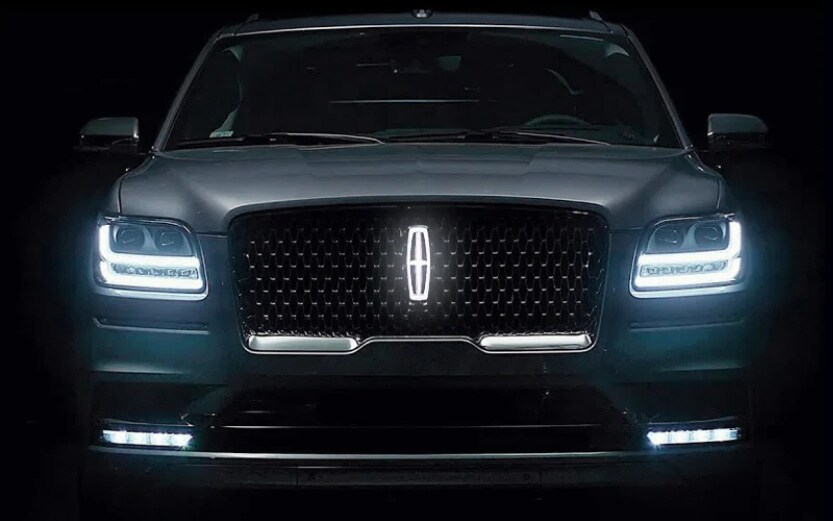 Interior view of a luxury car with dim dashboard lights, illustrating a weak battery's effect on electronics.