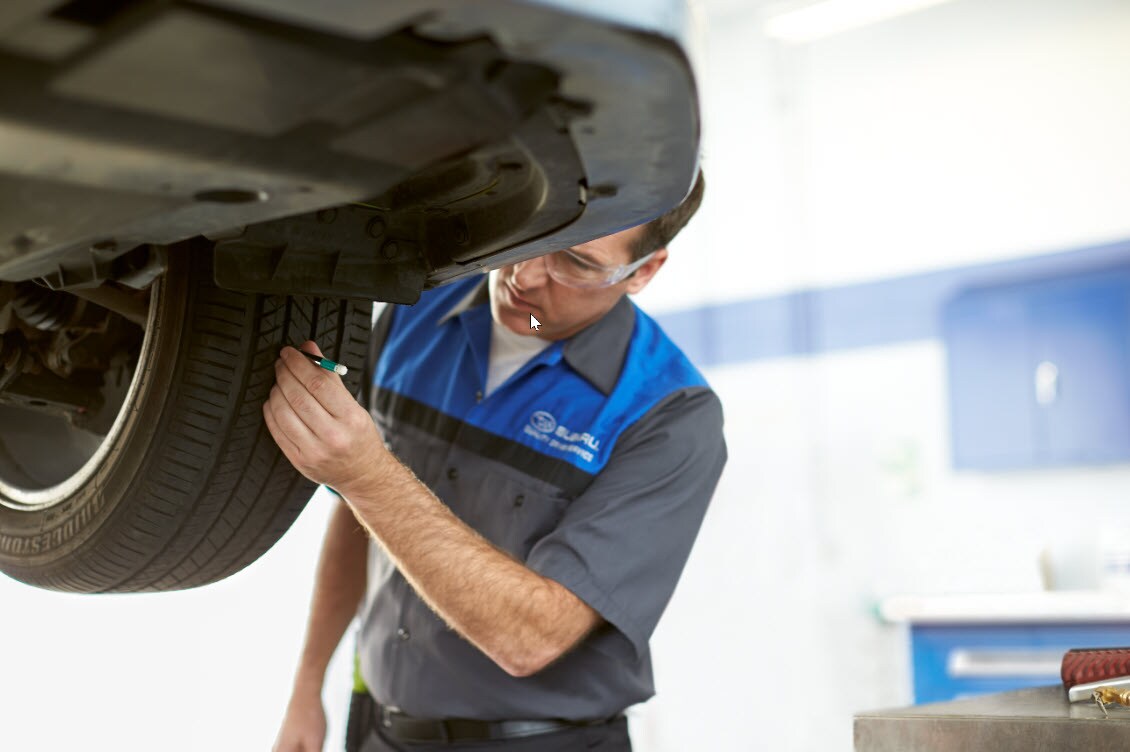 Tire Tread Depth Measurement and Tire Wear Check.jpg Certified Technician checking tire wear and measuring tire tread depth