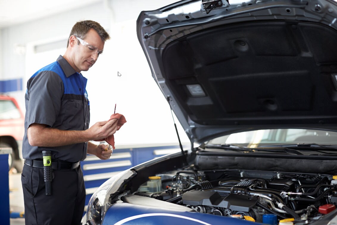 Subaru Service Technician Checking Dip stick after Oil Change.jpg Subaru Service Technician Checking Dip stick after Oil Change
