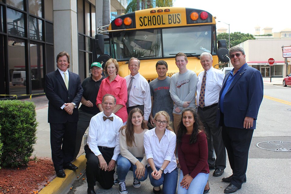 Photo of Pinellas County Students and Staff at Stuff the Bus event in front of bus photo of Pinellas County student and staff in front of bus at a local community event